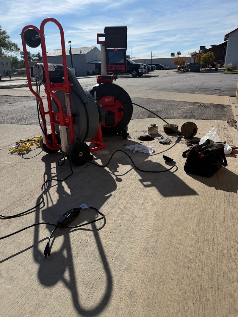 Drain cleaning machine and sewer camera set up at a commercial cleanout