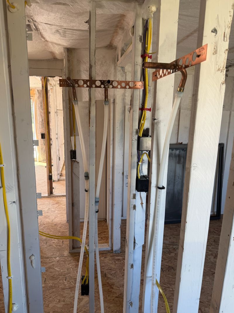 PEX and copper rough-in plumbing in new construction framing